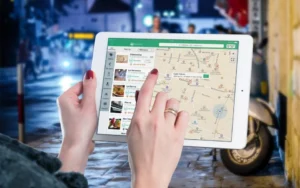Person browsing a local map search with nearby business listings on a tablet