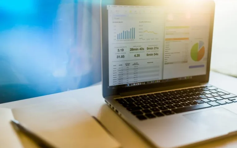 Laptop on a desk showing a dashboard of charts for tracking local SEO results