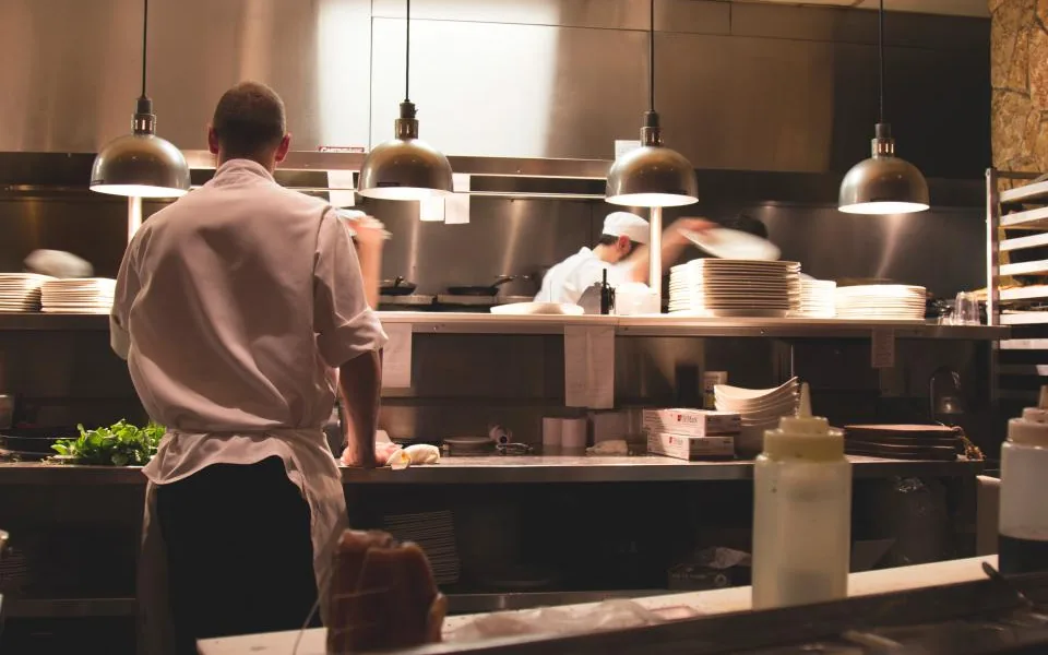 Chef preparing orders in a local restaurant kitchen during service